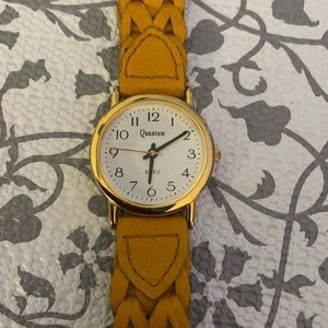 Quantum women’s yellow leather strap watch.